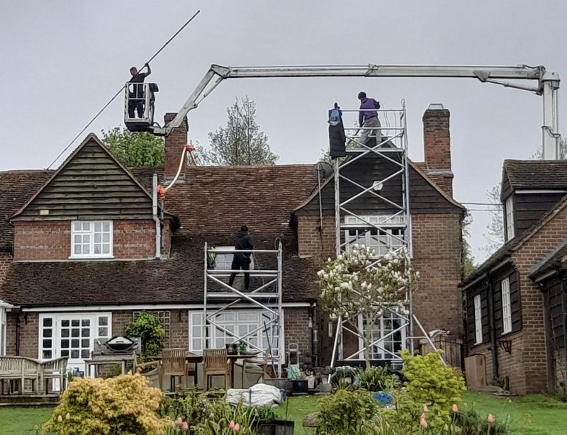The Roof Moss Cleaners using cherry picker and scaffolding to clean roof safely and professionally in Godmanchester, Cambridgeshire