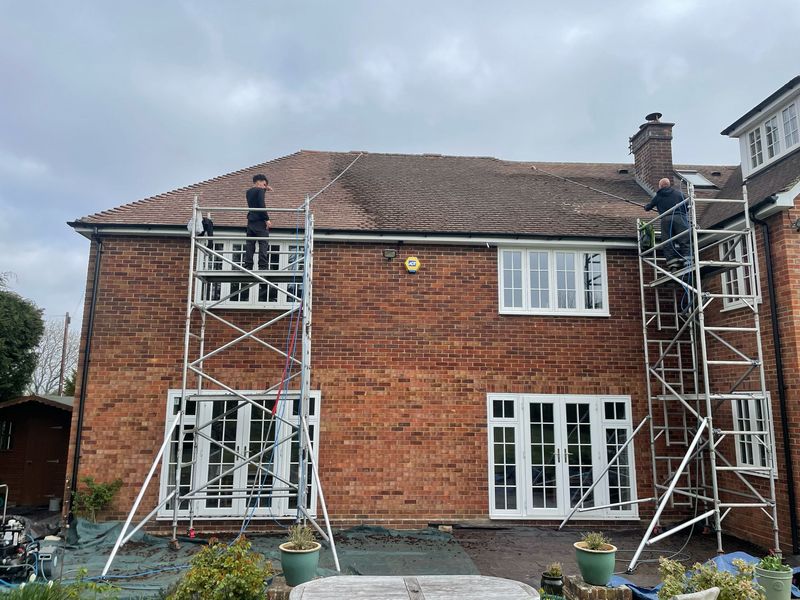Roof cleaning carried out safely from scaffold towers by The Roof Moss Cleaners in Godmanchester